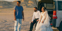 From left, Mohamad Ali Elyasmehr as Hamid, Majid Panahi as Ali, Hadis Pakbaten as Goli sit outside near a car