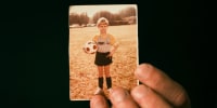 Chris Woods Sr. holds a childhood photo of himself.
