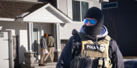 ICE agents look for someone at a home on Jan. 28, 2026 in Circle Pines, Minnesota.