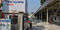 Narayana Multispeciality Hospital entrance where people are seen  walking to. 