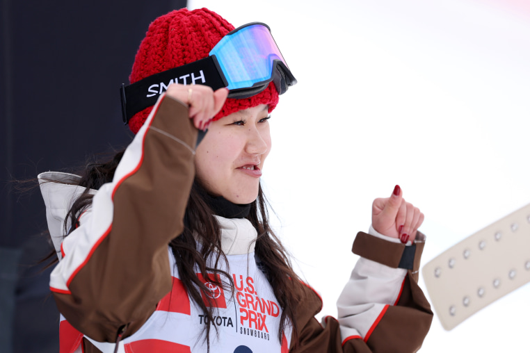 Bea Kim poses for her portrait to be taken while wearing snowboard attire. 