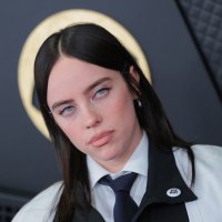 Billie Eilish wearing an "ICE OUT" pin on the GRAMMYs red carpet.